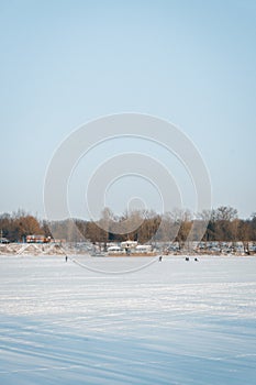 Winter nature landscape. Frosty trees on river side. Winter morning sunrise. Amazing field covered by hoarfrost