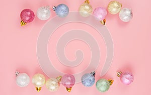 Winter New Year background. Multicolor Christmas Tree balls on pink