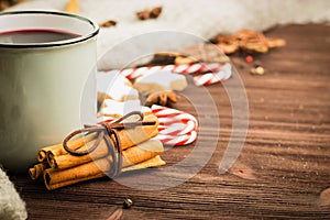 Winter and New Year theme. Christmas hot steaming cup of glint wine with spices, cinnamon, anise, cookies in a shape of star, red