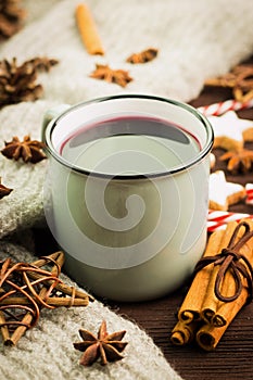 Winter and New Year theme. Christmas hot steaming cup of glint wine with spices, cinnamon, anise, cookies in a shape of star, red