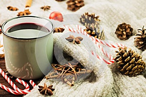 Winter and New Year theme. Christmas hot steaming cup of glint wine with spices, cinnamon, anise, cookies in a shape of star, red