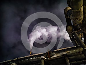 Winter night industrial landscape. Coal-fired power station with smoking chimneys against dramatic dark sky. Air