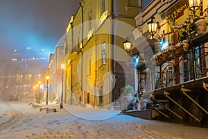 Winter night landscape, evening in the night snowy street under snowfall