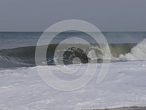 Bodyboarder on a Winter noreaster waves at indian river inlet photo