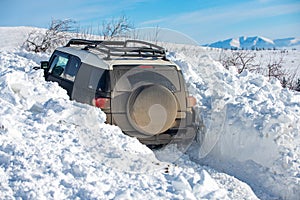 Winter offroad. Jeep in snow snowfall. Off road Adventure.