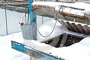 Winter. An old water well is covered in snow