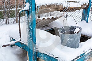 Winter. An old water well is covered in snow