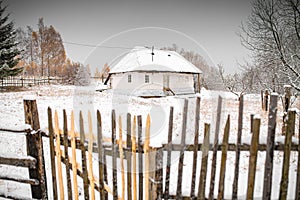 Winter over some beautiful authentic traditional villages in Romania with old houses and some autumn fall coloured trees in Rucar-