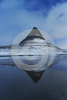 Winter panorama mirror reflection of Kirkjufell mountain blue hour sunrise Grundarfjordur Snaefellsnes Peninsula Iceland