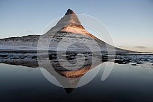 Winter panorama mirror reflection of Kirkjufell mountain blue hour sunrise Grundarfjordur Snaefellsnes Peninsula Iceland