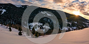 Winter panorama in mountains at sunrise