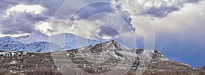 Winter Panorama of Oquirrh Mountain range snow capped, which includes The Bingham Canyon Mine or Kennecott Copper Mine, rumored th