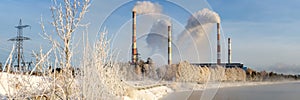 Winter panorama of Reftinskaya power plant with transmission lines and forest, Russia, the Urals,