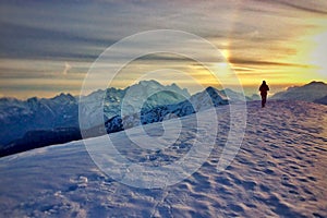 Winter panorama of snow-capped mountains at sunset