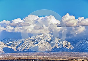 Winter Panoramic view of Snow capped Wasatch Front Rocky Mountains, Great Salt Lake Valley and Cloudscape from the Bacchus Highway photo