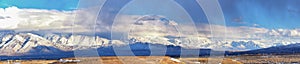 Winter Panoramic view of Snow capped Wasatch Front Rocky Mountains, Great Salt Lake Valley and Cloudscape. Utah