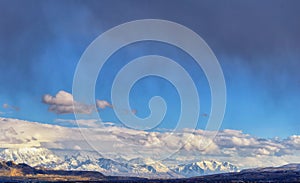 Winter Panoramic view of Snow capped Wasatch Front Rocky Mountains, Great Salt Lake Valley and Cloudscape. Utah