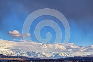 Winter Panoramic view of Snow capped Wasatch Front Rocky Mountains, Great Salt Lake Valley and Cloudscape. Utah