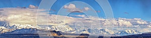 Winter Panoramic view of Snow capped Wasatch Front Rocky Mountains, Great Salt Lake Valley and Cloudscape. Utah