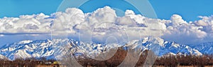 Winter Panoramic view of Snow capped Wasatch Front Rocky Mountains, Great Salt Lake Valley and Cloudscape. Utah