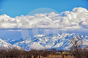 Winter Panoramic view of Snow capped Wasatch Front Rocky Mountains, Great Salt Lake Valley and Cloudscape. Utah