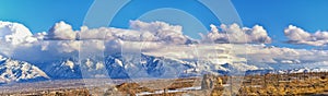 Winter Panoramic view of Snow capped Wasatch Front Rocky Mountains, Great Salt Lake Valley and Cloudscape. Utah