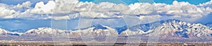 Winter Panoramic view of Snow capped Wasatch Front Rocky Mountains, Great Salt Lake Valley and Cloudscape. Utah