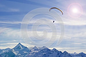 Winter paragliding in alps mountains