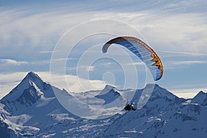 Winter paragliding over mountain peaks