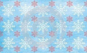 Winter pattern, snowflakes of white and carmine colors on blue background