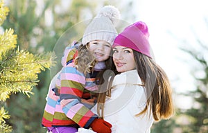 Winter and people concept - portrait of a happy mother and child