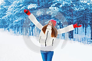 Winter and people concept - pretty woman rejoices winter weather