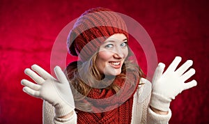Winter, people, happiness concept - woman in scarf and gloves wi
