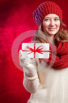 Winter, people, happiness concept - woman in scarf and gloves wi