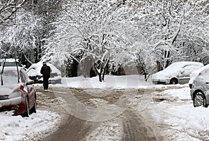 Winter. People walk on a very snowy roads. People step on an snow-stray pathway. Icy sidewalk. Ice on sidewalks