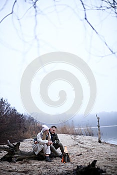 Winter picnic on baech with bonfire. Love story on winter foggy sand beach. valentines concept