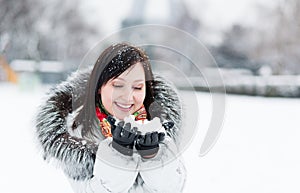 Winter portrait of a beautiful girl in fur hood