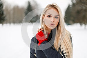 Winter portrait of a beautiful glamor model woman in a fashion