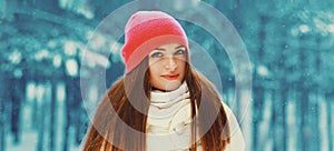 Winter portrait beautiful young woman outdoors on snowy background