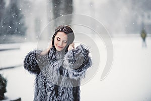 winter portrait of Beauty girl with snow