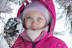 winter portrait, a girl of 7-9 years old, dressed in a bright jumpsuit