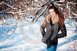 Winter portrait of a girl in a jacket with a fur collar.