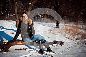 Winter portrait of a girl in a jacket with a fur collar.