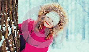 Winter portrait happy smiling little girl child outdoors on snowy background