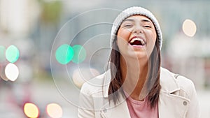 Winter portrait of laughing trendy girl with bokeh lights looking cheerful. Cute stylish and happy young woman smiling