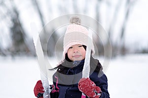 Winter portrait of little child girl wearing knitted hat