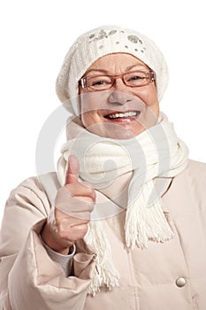 Winter portrait of old woman with thumb up