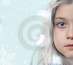 Winter portrait of a pretty little girl, with copy space and snowflakes