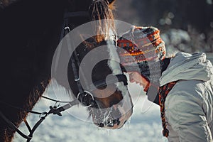 Winter portrait of teen girl with horse