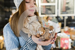 Winter portrait of woman with bowl of hazelnuts and walnuts